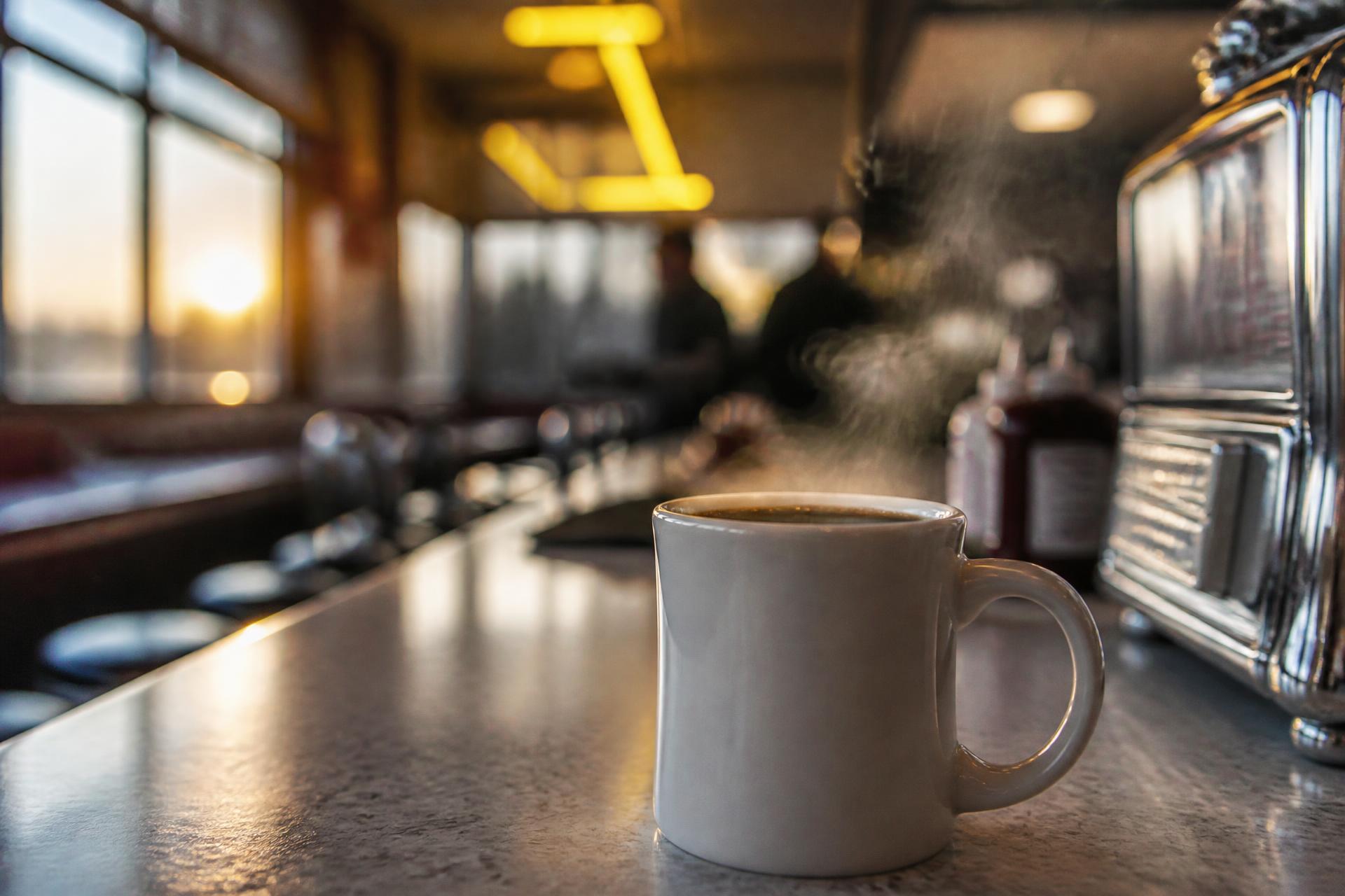 Steaming mug of coffee on a classic American diner counter